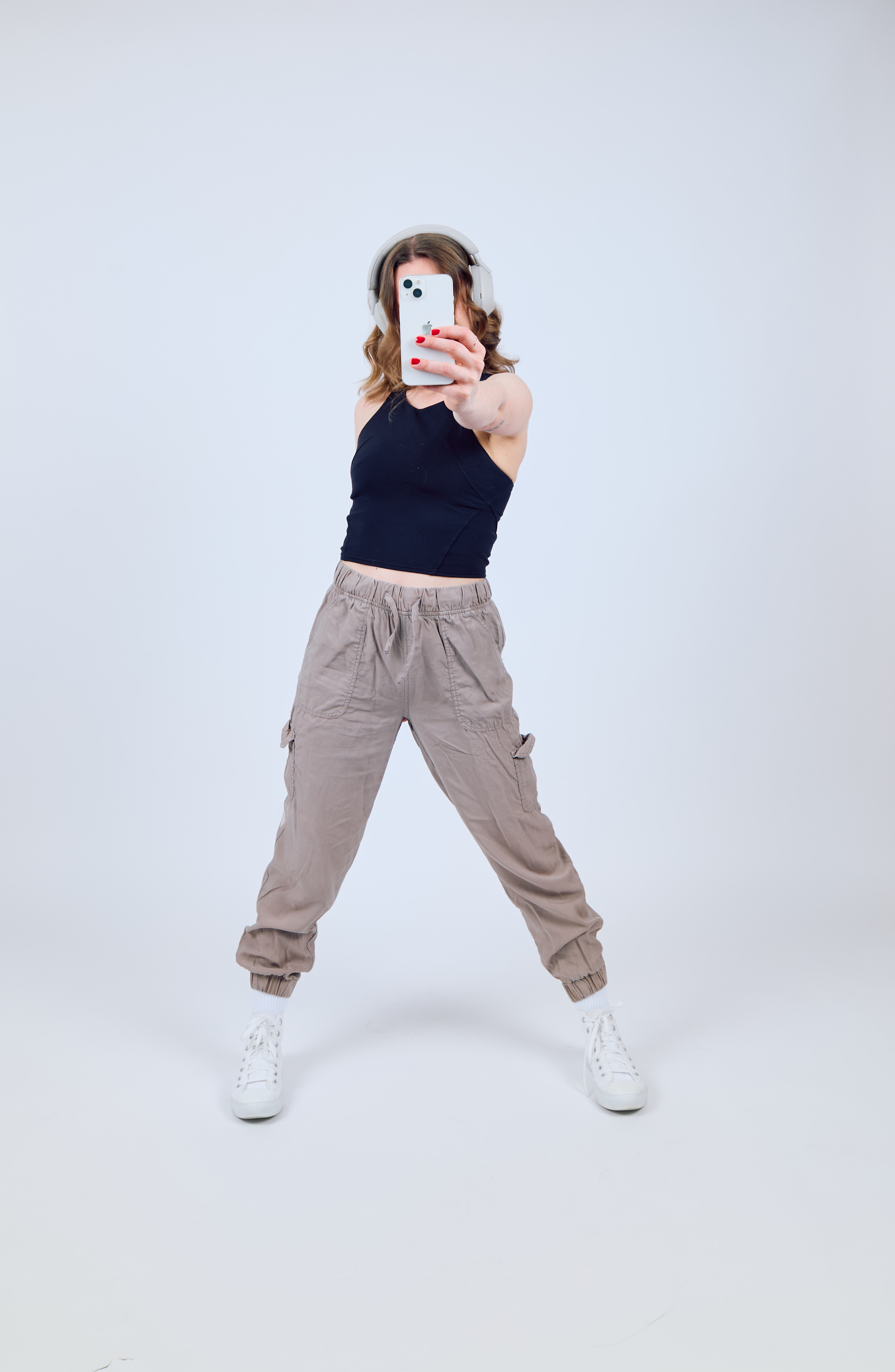 Danielle Ryan, Canadian UGC creator, holding her phone up while filming a vertical video ad in studio