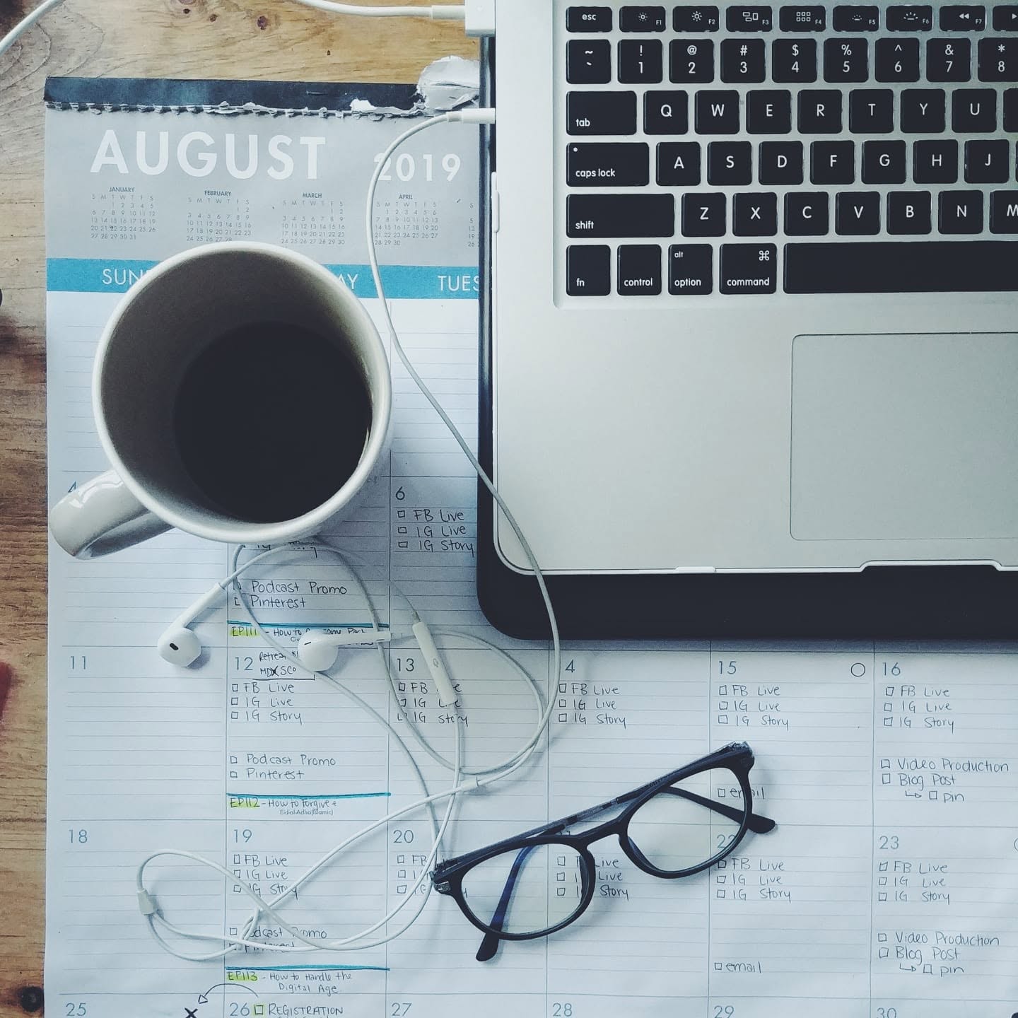 Danielle’s August 2019 content planning calendar with laptop and coffee