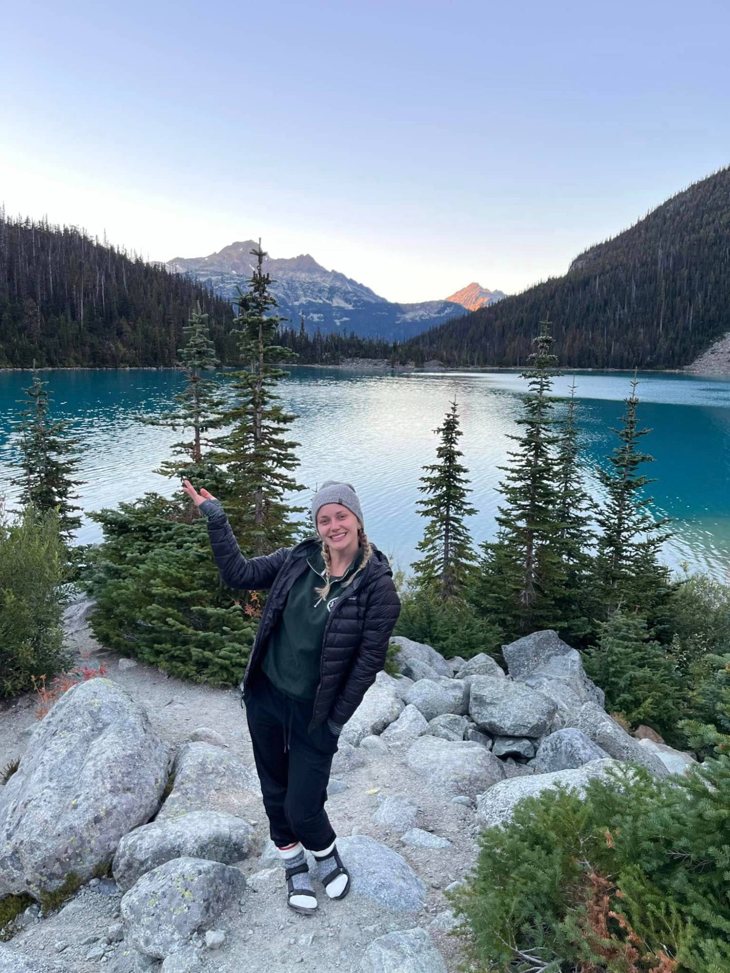 Danielle hiking by a turquoise lake in British Columbia